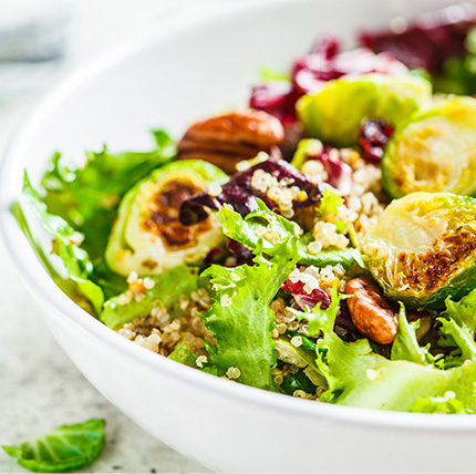 Bowl of salad with brussel sprouts and quinoa