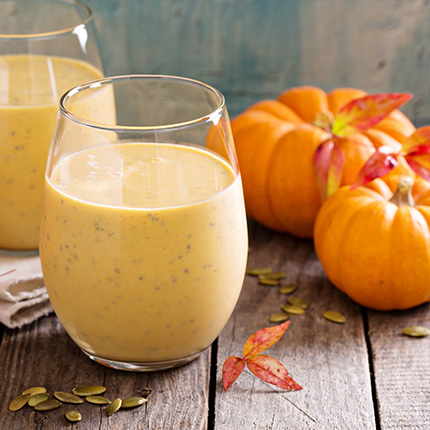 Two smoothies beside mini pumpkins